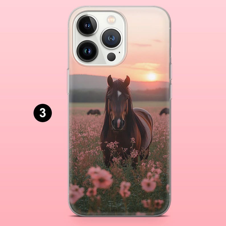 May include: A clear phone case with a brown horse in a field of pink flowers at sunset. The horse has a white marking on its forehead. The background shows a pink sky and distant hills. The case has a camera cutout.