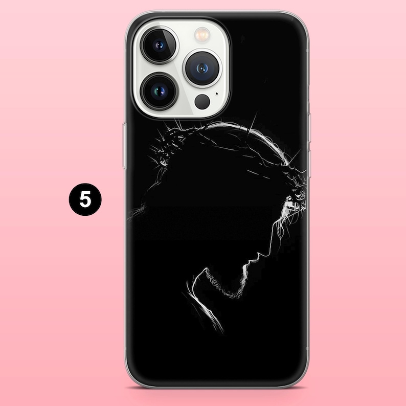 May include: Black phone case featuring a white silhouette of a person wearing a crown of thorns. The design is a profile view against a black background. The phone case has a clear border and a pink background.