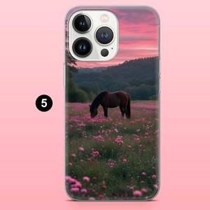 May include: A phone case depicting a brown horse grazing in a field of pink flowers, set against a sunset with pink and orange skies and green hills. The case has a clear border and a black number 5.