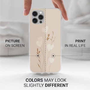 May include: A beige phone case with a floral design. The case features a print of white flowers and brown stems. The text on the case reads "PICTURE ON SCREEN" and "PRINT IN REAL LIFE". The text "COLORS MAY LOOK SLIGHTLY DIFFERENT" is also visible.