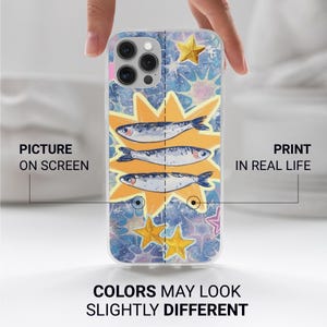May include: A clear phone case featuring a colorful design with three fish, starbursts, and stars. The case has the text "PICTURE ON SCREEN" and "PRINT IN REAL LIFE" with the text "COLORS MAY LOOK SLIGHTLY DIFFERENT" at the bottom.