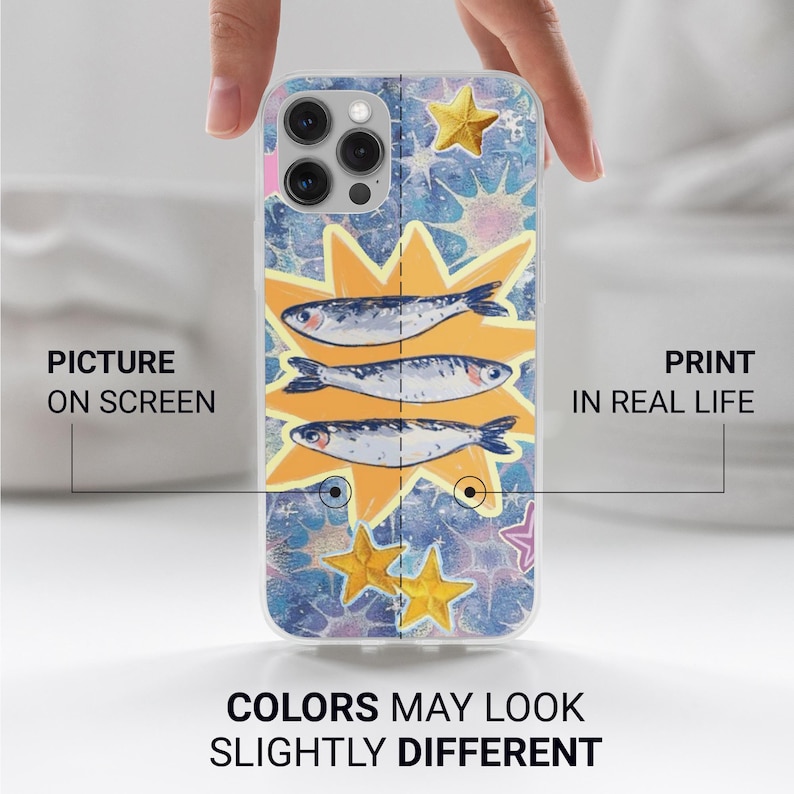 May include: A clear phone case featuring a colorful design with three fish, starbursts, and stars. The case has the text "PICTURE ON SCREEN" and "PRINT IN REAL LIFE" with the text "COLORS MAY LOOK SLIGHTLY DIFFERENT" at the bottom.