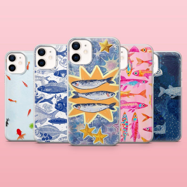 May include: A collection of phone cases with various fish-themed designs. The cases feature illustrations of sardines, koi, and other fish in vibrant colors. Some cases have a blue and white color scheme, while others are pink or blue.