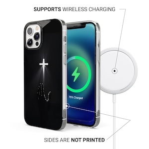 May include: Black phone case with a white cross design and a hand reaching upwards. The phone is charging wirelessly, as indicated by the lightning bolt symbol on the screen. The text "SUPPORTS WIRELESS CHARGING" and "SIDES ARE NOT PRINTED" are visible.