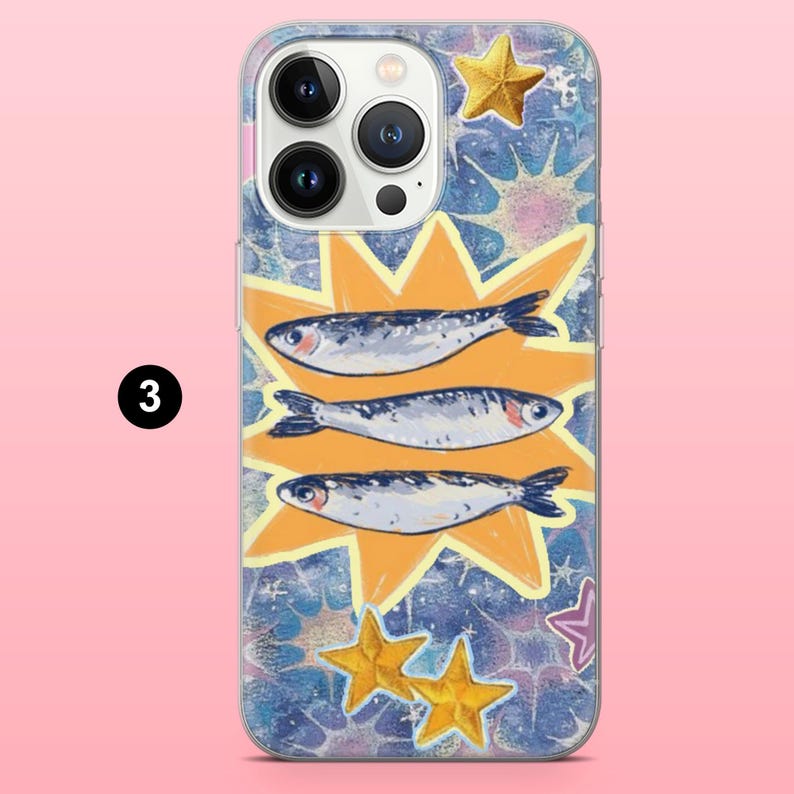 May include: A phone case featuring a whimsical design with three sardines set against a yellow burst, surrounded by gold stars and a textured blue background. The case has a glossy finish and a camera cutout.