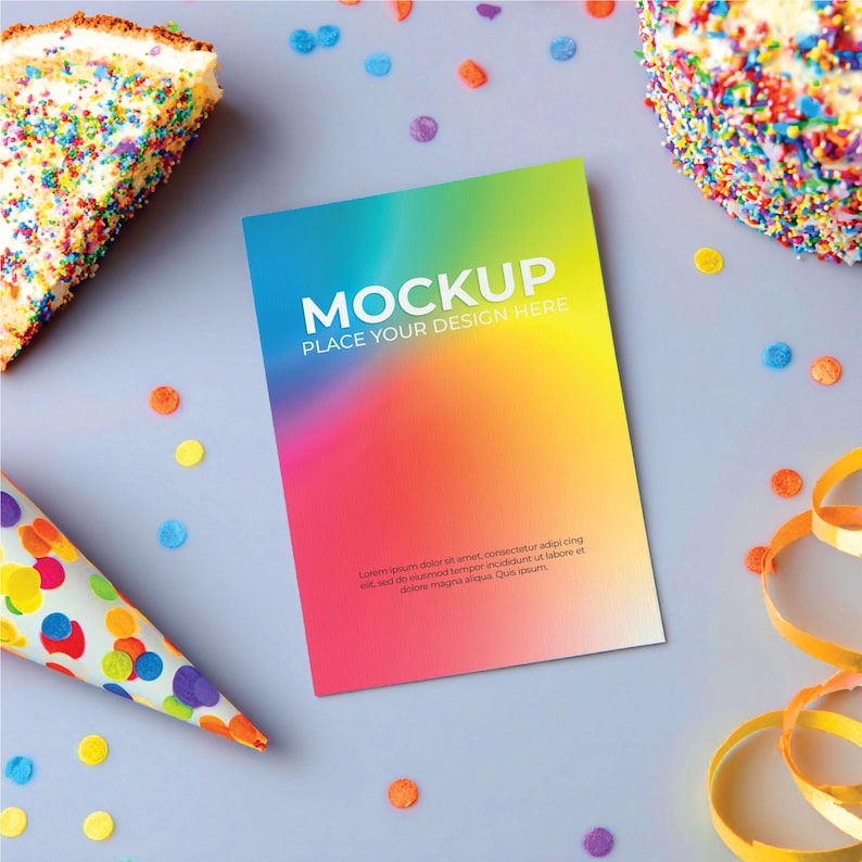 May include: A colorful mockup card with the text "MOCKUP PLACE YOUR DESIGN HERE" is the focal point, surrounded by festive elements. A slice of cake and confetti are scattered on a gray surface, with party streamers and a party hat.