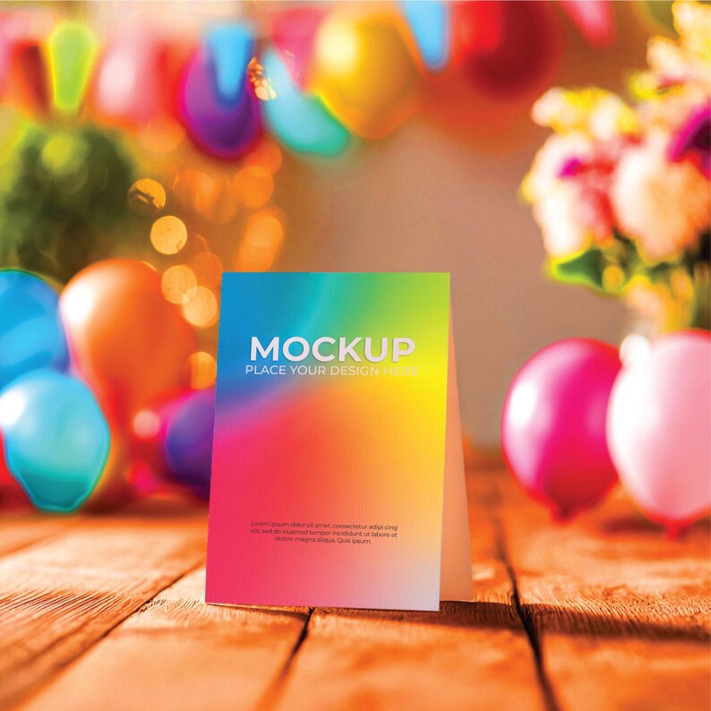May include: A colorful mockup card with the word "MOCKUP" in white, set against a vibrant gradient background of blue, green, yellow, orange, and pink. The card is on a wooden surface, with balloons and flowers in the background.