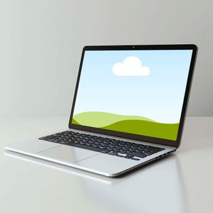 May include: A silver laptop with a black keyboard. The screen shows a landscape with a blue sky, a white cloud, and green hills. The laptop is open and angled, placed on a white surface.
