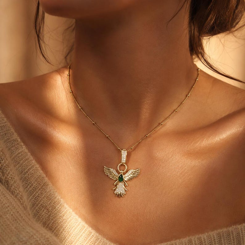 Women’s gold-tone angel wing necklace with sparkling CZ stones.