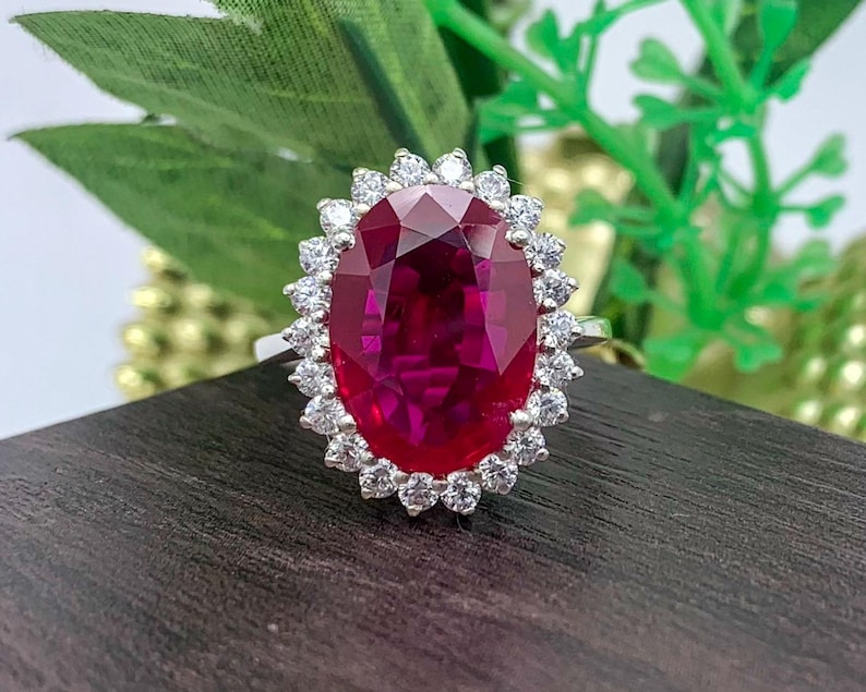lab ruby oval halo ring in 925 sterling silver with sparkling white stones, elegant vintage-inspired statement jewelry.