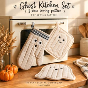 May include: A 3-piece sewing pattern set titled Ghost Kitchen Set, featuring a beige oven mitt with a black and white gingham trim, a square potholder with a ghost face, and a ghost-shaped mat, all with black embroidered details.
