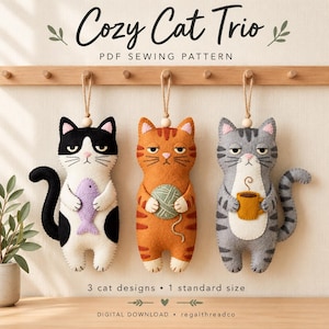 May include: A PDF sewing pattern titled Cozy Cat Trio featuring three felt cat ornaments hanging from a wooden rack. The cats are black and white with a fish, orange tabby with a yarn ball, and gray tabby with a coffee mug. Text includes 3 cat designs, 1 standard size, and digital download.
