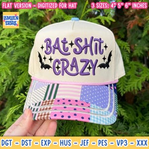 May include: A cream-colored baseball cap featuring purple embroidered text that reads BAT SHIT CRAZY, accented by black bat silhouettes and small star shapes. The brim displays a colorful patchwork pattern in pink, blue, green, and brown.