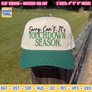 Op de afbeelding: Een crèmekleurige baseballpet met een donkergroene klep. De voorkant bevat zwarte cursieve tekst met Sorry. Can't. en groene blokletters met TOUCHDOWN SEASON. Het ontwerp is beschikbaar in de maten 10, 13 en 15 cm.