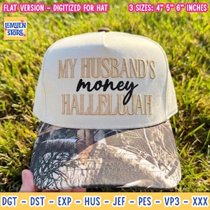 May include: A cream-coloured baseball cap with a camouflage-patterned brim. The front features embroidered text that reads MY HUSBAND'S money HALLELUJAH. The design is available in three sizes: 10.16 cm, 12.7 cm, and 15.24 cm.