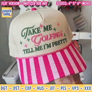 May include: A cream-colored trucker hat with a pink and white striped brim. The front features embroidered text that reads Take Me Golfing & Tell Me I'm Pretty in green and pink, accented by small star shapes. The hat includes a pink cord trim.