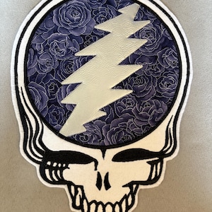 May include: A set of three ceramic nesting bowls in graduating sizes. The bowls feature a speckled, matte finish in shades of cream, light brown, and dark brown. The largest bowl measures approximately 8 inches in diameter.