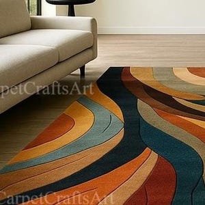 May include: A vibrant area rug with an abstract, flowing pattern. The rug showcases curved lines in shades of orange, brown, blue, and beige. It's positioned on a wooden floor, with a beige sofa and black side table visible in the background.