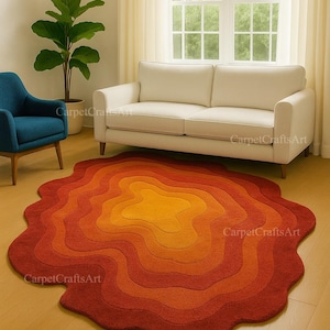 May include: A vibrant, layered rug in shades of orange and red, reminiscent of a contour map. The rug sits on a light wood floor, with a white sofa and blue chair visible. The rug's design adds a warm, inviting touch to the room, with a retro feel.