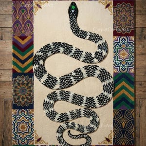 May include: A rectangular rug featuring a large snake design. The snake is black and white with a green eye. The rug has a cream-colored center and a patterned border with geometric and floral designs in various colors. The text "CarpetCraftsArt" is visible.