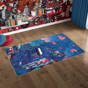 May include: A rectangular area rug with a vibrant cityscape design in shades of blue, purple, and pink. The rug features buildings, streets, and neon signs, creating a modern, artistic aesthetic. The rug is placed on a wooden floor.