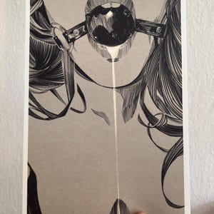 May include: Monochrome art print showing a detailed illustration. The artwork presents a stylized, abstract design with flowing lines and a central, geometric shape. The print is held by a hand.