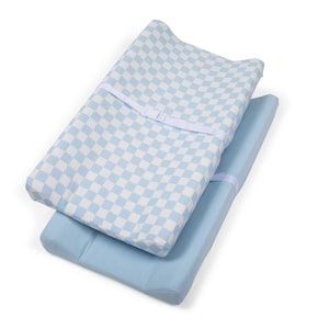 May include: Two baby changing mats. The top mat has a light blue and white chequered pattern. The bottom mat is a solid light blue. Both mats have a white strap with a buckle.