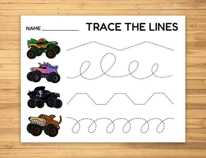 May include: A white worksheet with the text "TRACE THE LINES" and a space for a name. It features four colorful monster truck illustrations and dotted lines for tracing practice. The trucks are green, pink, purple, and brown.