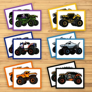 May include: A selection of illustrated monster truck cards with coloured borders. The trucks feature designs such as a shark and flames, with large wheels. The cards are arranged on a wooden surface. Measurements are not applicable.