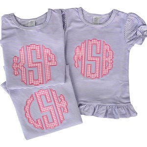May include: Two purple and white striped shirts with pink gingham monogrammed initials. The shirt on the left has the initials "KSP" and the shirt on the right has the initials "MSB".