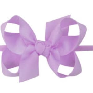 May include: A light purple hair bow with a simple design. The bow is made of a soft, silky fabric and is tied with a knot in the center.