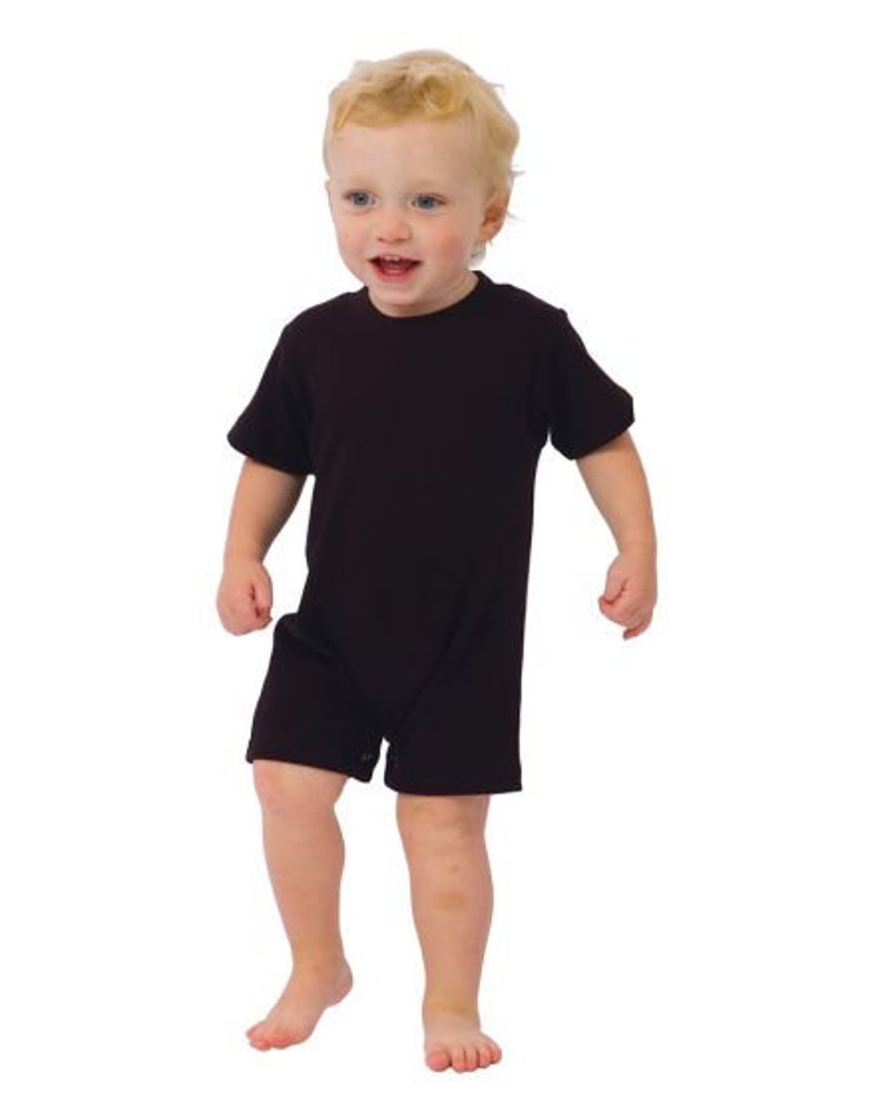 May include: A toddler wearing a dark brown short-sleeved onesie. The onesie has a round neckline and a snap closure at the crotch.