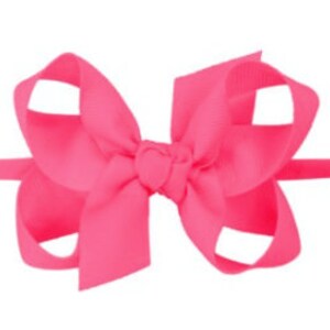 May include: A bright pink hair bow with a simple design. The bow is made of a soft, silky fabric and is tied with a knot in the center.