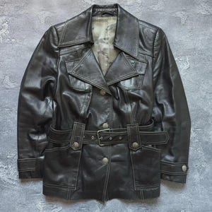 May include: A set of three ceramic mugs with a speckled, matte finish. The mugs are in shades of cream, light gray, and dark gray. Each mug has a simple, minimalist design, perfect for coffee or tea.