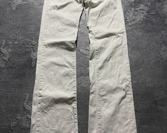 Vaqueros acampanados vintage Dolce & Gabbana blancos estilo años 2000 con efecto desgastado y logo, talla 24/38