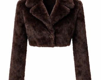 May include: A cropped, brown faux fur jacket with a classic collar and long sleeves. The jacket has a tailored fit and a single-button closure. The fur appears soft and plush, creating a luxurious look. The jacket is designed to be worn as outerwear.