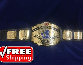 May include: A gold and black Intercontinental Heavyweight Wrestling Championship belt. The belt features a large central plate with a globe design and the words "Intercontinental Heavyweight Wrestling Champion". The belt has gold side plates and a black leather strap.