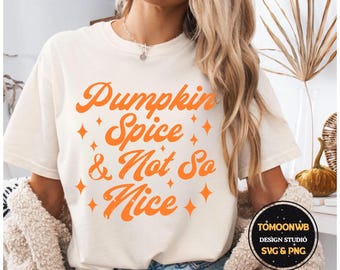 May include: Cream-colored t-shirt with the phrase "Pumpkin Spice & Not So Nice" in orange script. The design includes orange diamond shapes. The shirt is part of a fall-themed collection.