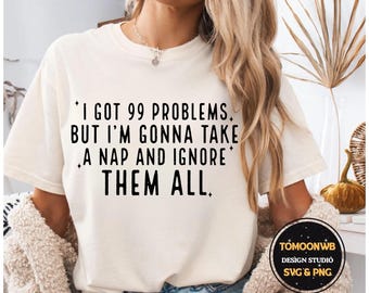 May include: Cream-colored t-shirt with the text "I GOT 99 PROBLEMS, BUT I'M GONNA TAKE A NAP AND IGNORE THEM ALL." The shirt also features a design studio logo. The shirt is a relaxed fit.