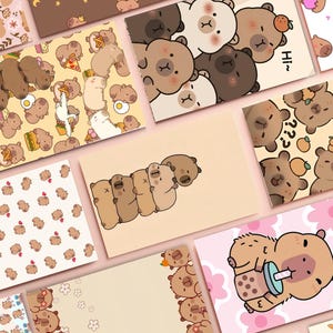 May include: A collection of illustrated postcards featuring cartoon bears in various poses and settings. The cards showcase a range of designs, including bears with food, in groups, and with text. The color palette includes shades of brown, beige, pink, and white.