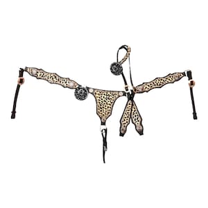 May include: A leather horse breast collar featuring a leopard print pattern on the chest and shoulder straps. The piece includes circular silver-toned conchos with star and horse head motifs, dark brown leather edges, and metallic buckles.
