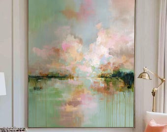 May include: Large abstract painting with a serene landscape scene. The artwork features a blend of soft colors, including green, pink, and peach, creating a calming atmosphere. The painting is framed and hangs on a white wall, enhancing the room's decor.