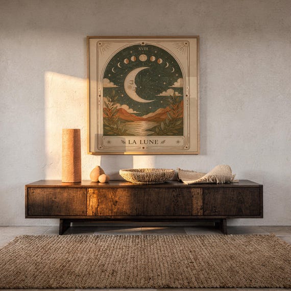 Terracotta spiritual moon tarot art framed on dark wooden console table in warm sunlit room.