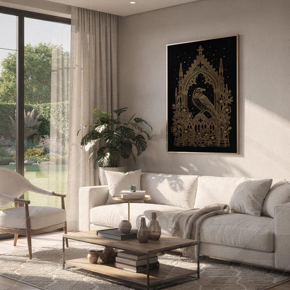 Gothic raven wall art print hanging above a white sofa in a living room with garden views.