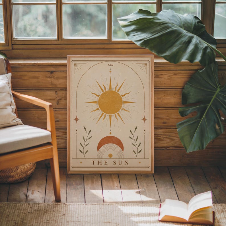 Vintage style celestial sun tarot card poster framed in cozy rustic room with plants