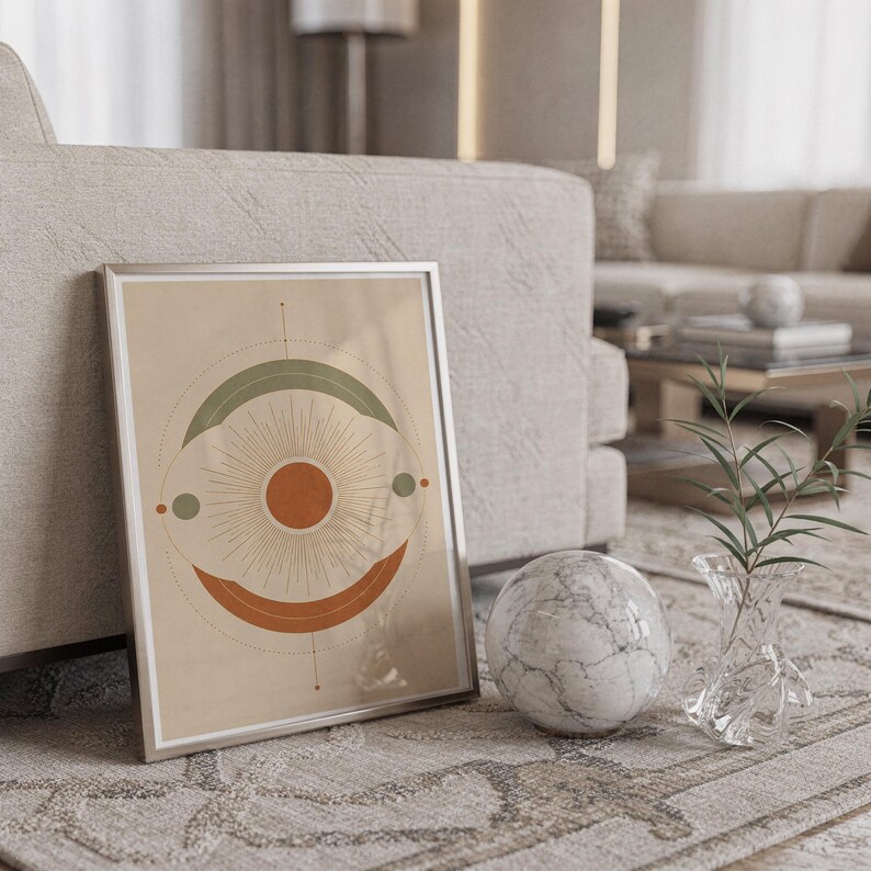 Abstract sun wall art print standing on a countertop in a modern white kitchen.