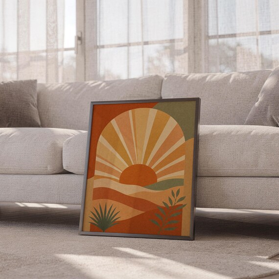 Boho sun arch print leaning against a white sofa in a bright living room with sheer curtains.