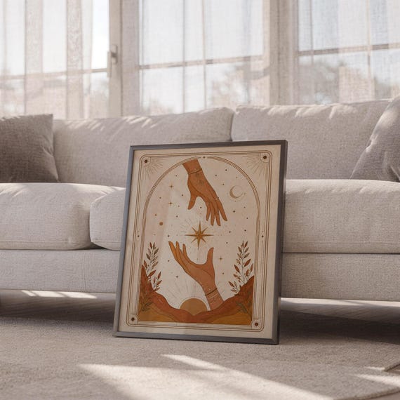 Boho magic hands poster framed leaning against sofa in cozy sunlit living room setup.