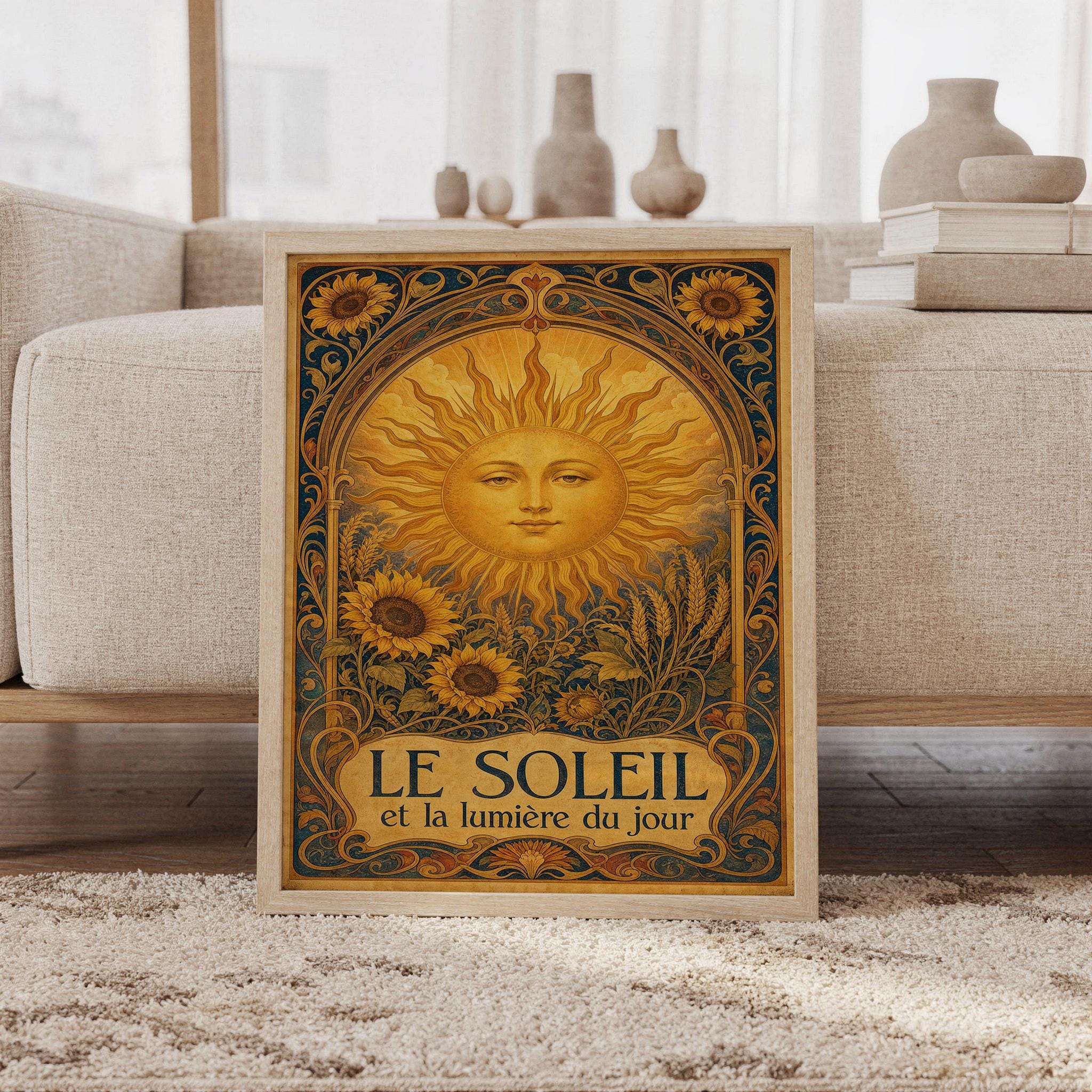 Art nouveau sunflower wall art print featuring glowing golden yellow, ochre, deep teal, and warm brown hues, a serene celestial sun face, sunflowers, wheat, and ornate botanical scrollwork, framed and leaning against a beige sofa on a textured rug in a bright Scandinavian living room.