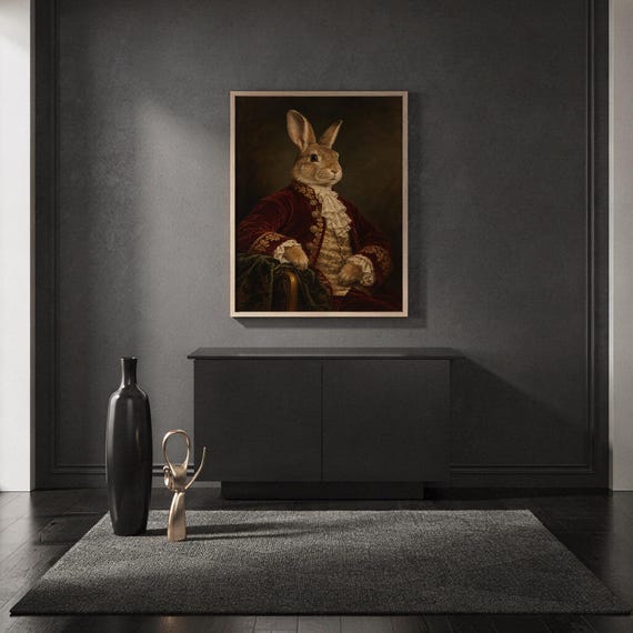 Regal rabbit portrait wall art print standing on a countertop in a modern white kitchen.